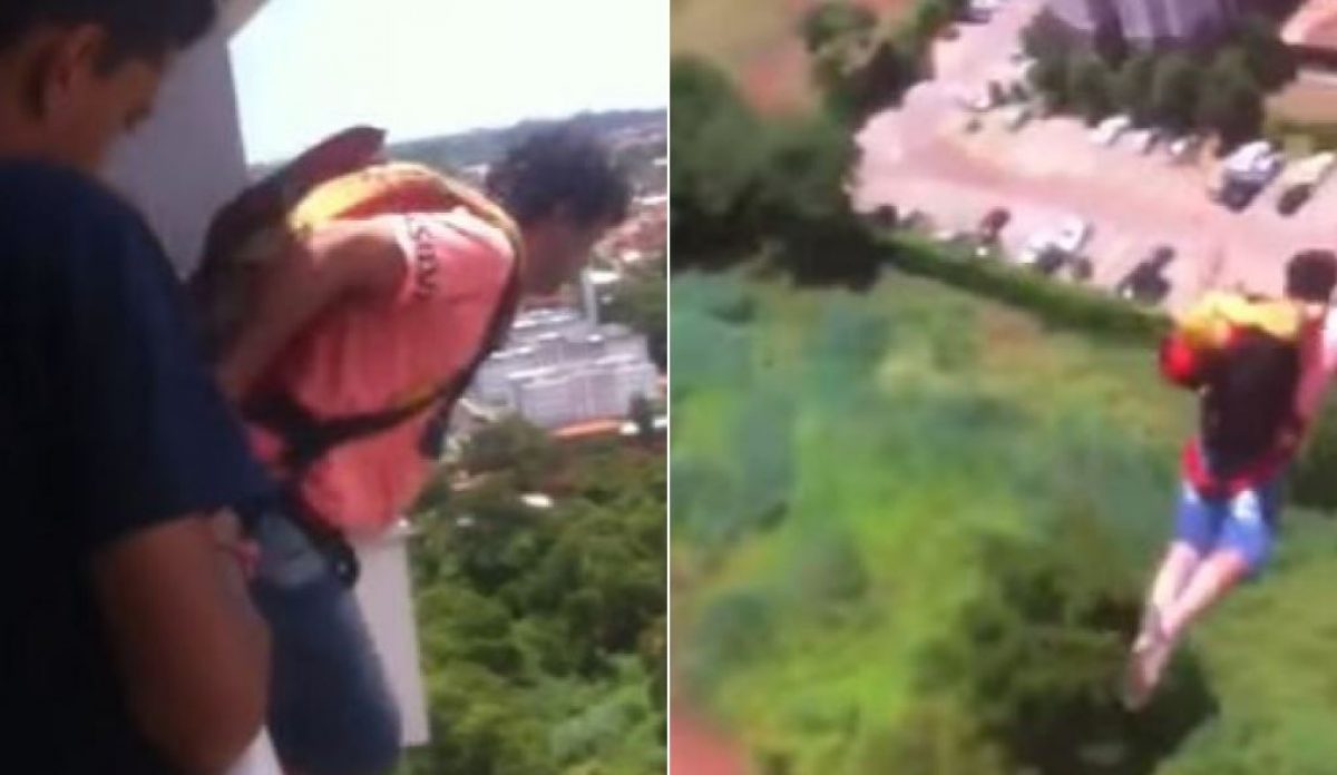 Close de um homem pulando de paraquedas perto do solo com um