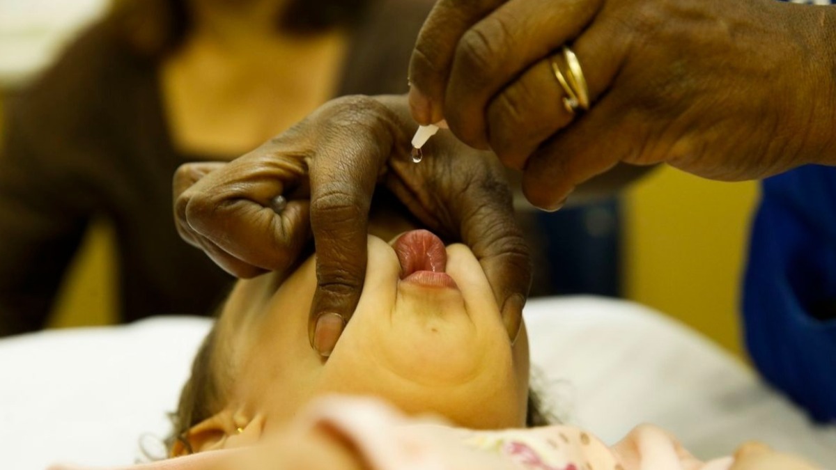 criança toma vacina pólio