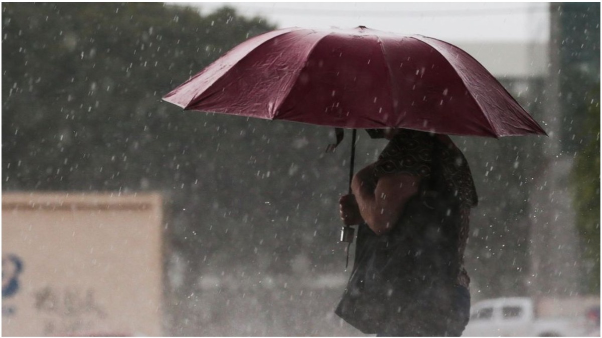 Mulher se protege da chuva com sombrinha